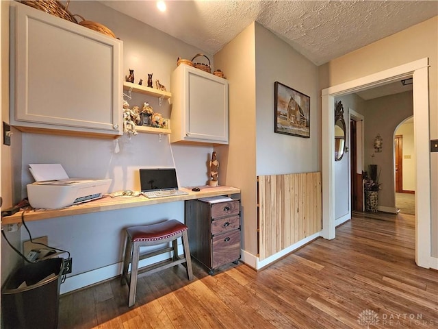 3054 Carpenter Rd, Jefferson Twp, OH 45335 - home office with arched walkways, wood finished floors, and a textured ceiling