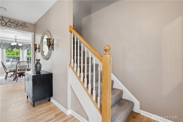 25 Huntley Ct, Springboro, OH 45066 - stairway with a chandelier and wood finished floors