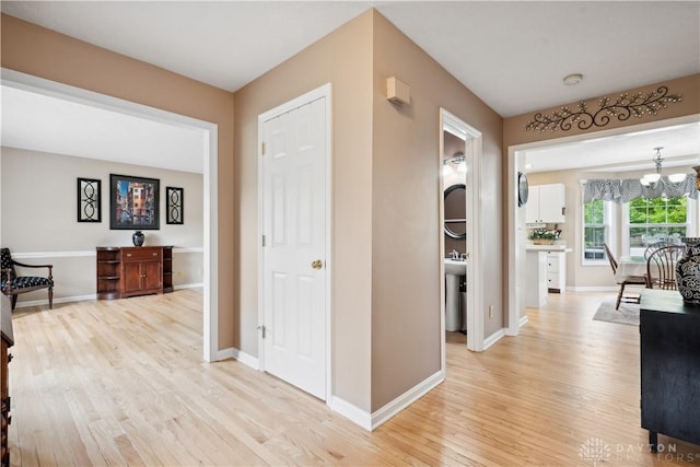 25 Huntley Ct, Springboro, OH 45066 - hall with light wood-style flooring and a chandelier