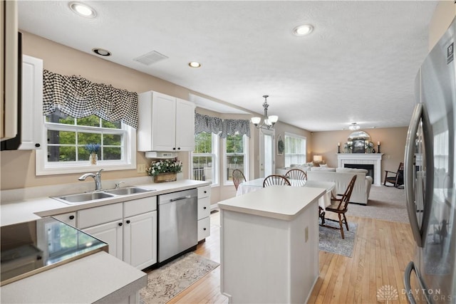 25 Huntley Ct, Springboro, OH 45066 - kitchen with appliances with stainless steel finishes, a center island, white cabinetry, open floor plan, and recessed lighting