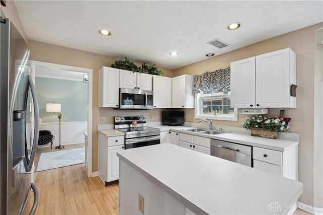 25 Huntley Ct, Springboro, OH 45066 - kitchen with appliances with stainless steel finishes, white cabinets, light wood-type flooring, light countertops, and recessed lighting