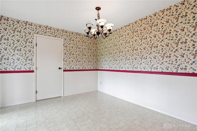 242 Poe Ln, Xenia, OH 45385 - unfurnished room featuring wallpapered walls and a chandelier
