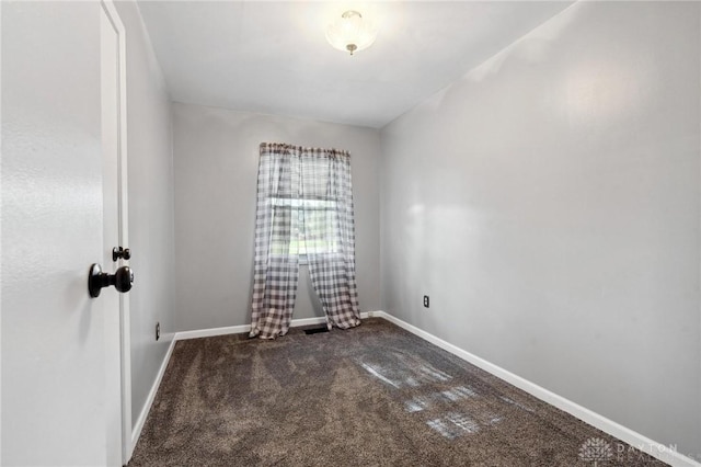 242 Poe Ln, Xenia, OH 45385 - empty room with dark colored carpet and baseboards