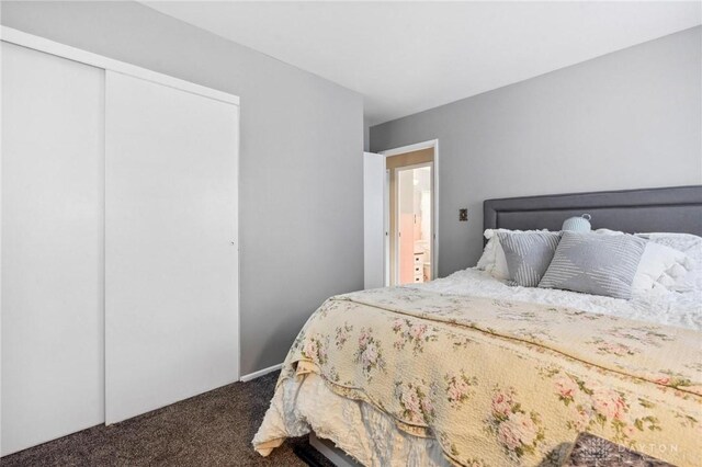 242 Poe Ln, Xenia, OH 45385 - bedroom with dark colored carpet and a closet