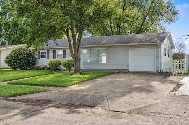 242 Poe Ln, Xenia, OH 45385 - ranch-style house featuring a garage, driveway, and roof with shingles