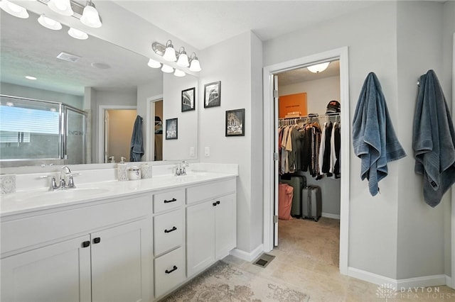 3109 Running Deer Trl, Franklin Twp, OH 45005 - full bathroom featuring a spacious closet, a shower stall, double vanity, and tile patterned flooring