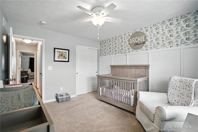 3109 Running Deer Trl, Franklin Twp, OH 45005 - carpeted bedroom with a nursery area, wainscoting, and a ceiling fan