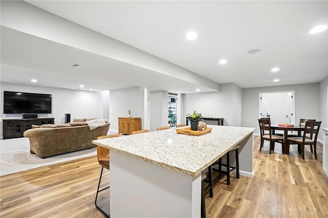 3109 Running Deer Trl, Franklin Twp, OH 45005 - kitchen with a kitchen bar, a kitchen island, light wood finished floors, and recessed lighting