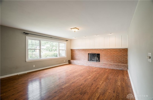 187 Cheltenham Dr, Washington Twp, OH 45459 - unfurnished living room with wood finished floors and a fireplace