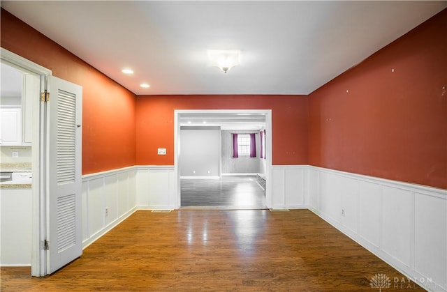 187 Cheltenham Dr, Washington Twp, OH 45459 - unfurnished room with wainscoting, wood finished floors, and a decorative wall