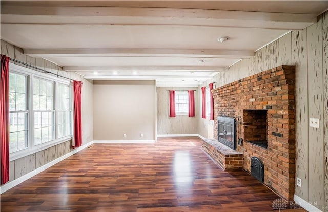 187 Cheltenham Dr, Washington Twp, OH 45459 - unfurnished living room featuring wood finished floors, beamed ceiling, a fireplace, and wooden walls