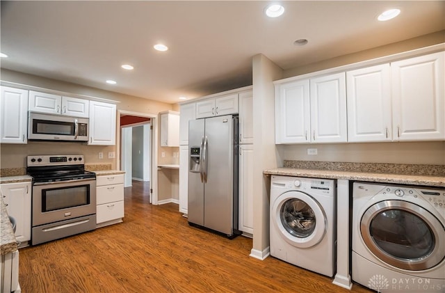 187 Cheltenham Dr, Washington Twp, OH 45459 - kitchen featuring stainless steel appliances, independent washer and dryer, white cabinetry, wood finished floors, and recessed lighting
