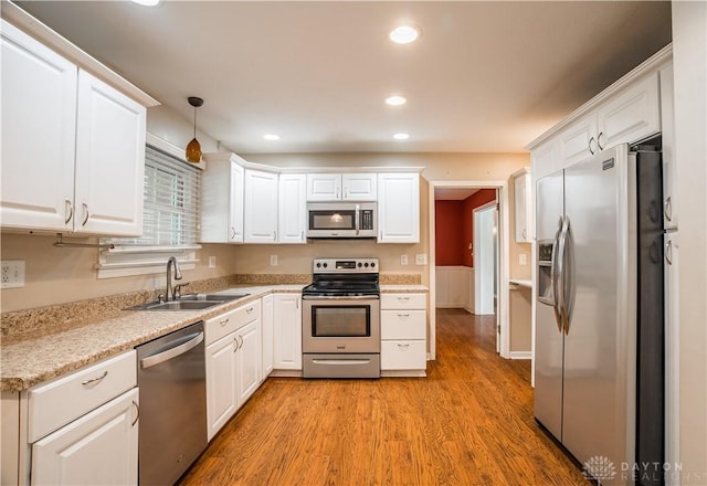 187 Cheltenham Dr, Washington Twp, OH 45459 - kitchen featuring stainless steel appliances, white cabinetry, light wood-style floors, light countertops, and recessed lighting