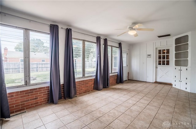 187 Cheltenham Dr, Washington Twp, OH 45459 - spare room with a ceiling fan, brick wall, healthy amount of natural light, and light tile patterned floors