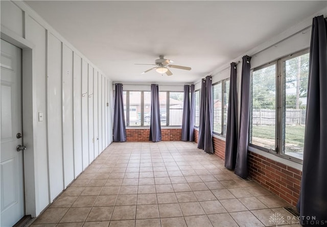 187 Cheltenham Dr, Washington Twp, OH 45459 - unfurnished sunroom with brick wall, plenty of natural light, and tile patterned flooring