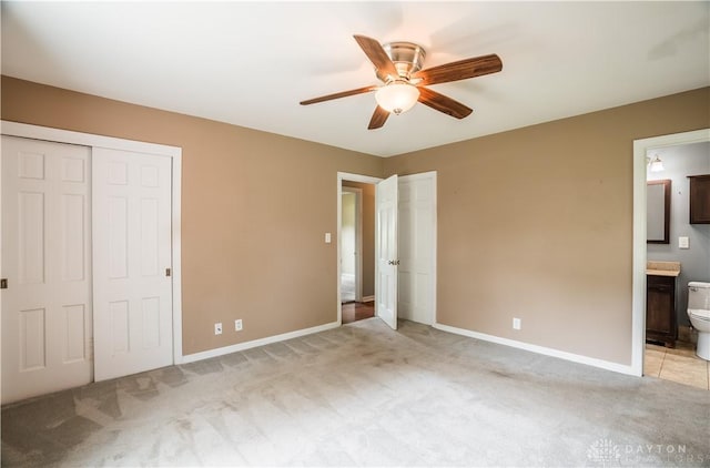 187 Cheltenham Dr, Washington Twp, OH 45459 - unfurnished bedroom featuring light colored carpet, two closets, ensuite bathroom, and ceiling fan