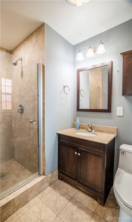 187 Cheltenham Dr, Washington Twp, OH 45459 - full bath with vanity, tiled shower, and tile patterned flooring