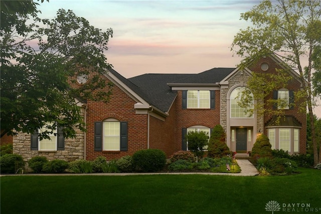 9764 Olde Georgetown Way, Dayton, OH 45458 - view of front of house with stone siding, a yard, brick siding, and roof with shingles