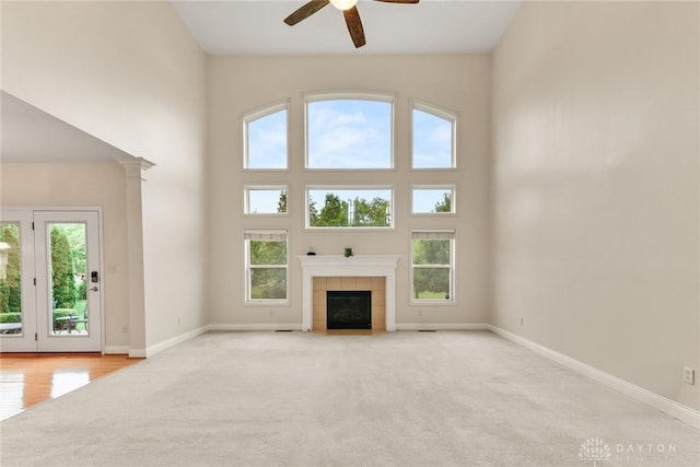 9764 Olde Georgetown Way, Dayton, OH 45458 - unfurnished living room featuring a ceiling fan, a towering ceiling, plenty of natural light, and carpet flooring