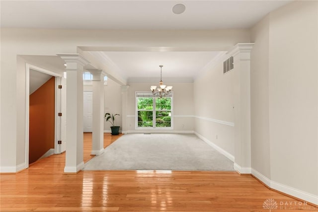 9764 Olde Georgetown Way, Dayton, OH 45458 - unfurnished room with light wood-style flooring, a chandelier, crown molding, and decorative columns