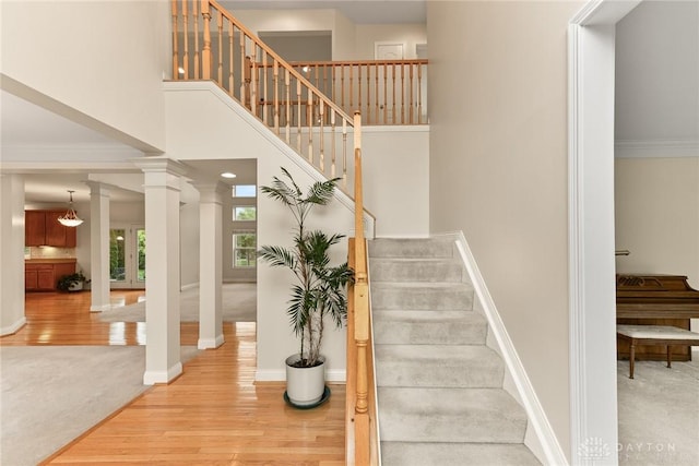 9764 Olde Georgetown Way, Dayton, OH 45458 - stairs with wood finished floors, ornate columns, and ornamental molding