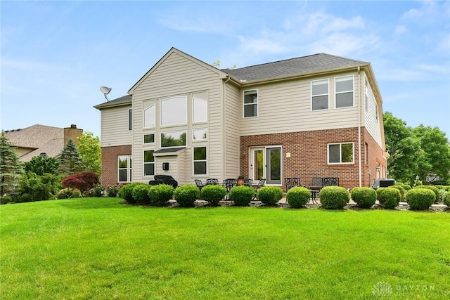 9764 Olde Georgetown Way, Dayton, OH 45458 - rear view of property with brick siding and a lawn