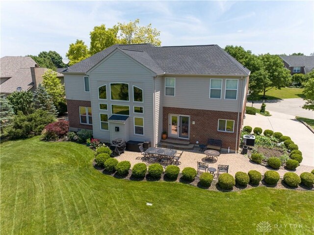 9764 Olde Georgetown Way, Dayton, OH 45458 - back of property featuring a patio, a yard, brick siding, and entry steps