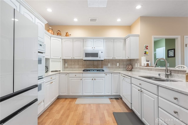 866 Deer Run Rd, Centerville, OH 45459 - kitchen with white appliances, white cabinetry, light wood-type flooring, decorative backsplash, and recessed lighting