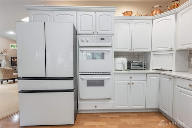 866 Deer Run Rd, Centerville, OH 45459 - kitchen featuring white appliances, white cabinets, decorative backsplash, light wood-type flooring, and light stone counters