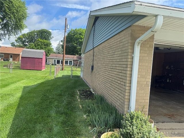 435 Nies Ave, Englewood, OH 45322 - view of side of home featuring brick siding, a garage, and a shed