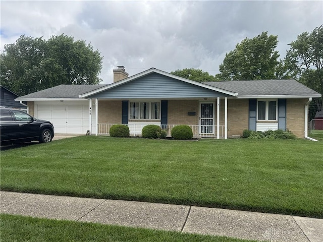 435 Nies Ave, Englewood, OH 45322 - single story home with covered porch, brick siding, a garage, and a front lawn