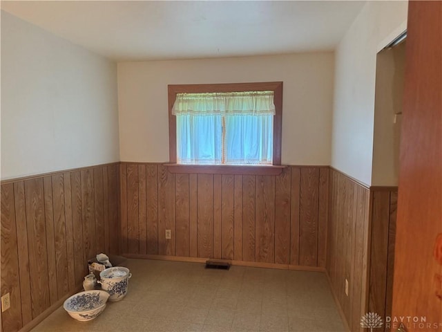 435 Nies Ave, Englewood, OH 45322 - empty room with wainscoting, wood walls, and tile patterned floors