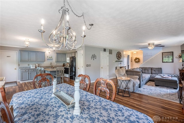30 Salem Dr, Springboro, OH 45066 - dining area featuring a chandelier, dark wood finished floors, a ceiling fan, and crown molding