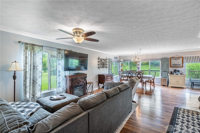 30 Salem Dr, Springboro, OH 45066 - living area featuring crown molding, a chandelier, a glass covered fireplace, wood finished floors, and a ceiling fan