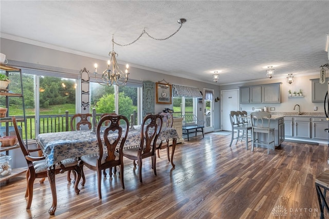30 Salem Dr, Springboro, OH 45066 - dining space featuring a textured ceiling, a chandelier, dark wood-type flooring, and crown molding