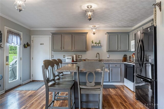 30 Salem Dr, Springboro, OH 45066 - kitchen with white appliances, gray cabinets, dark wood finished floors, a center island, and ornamental molding