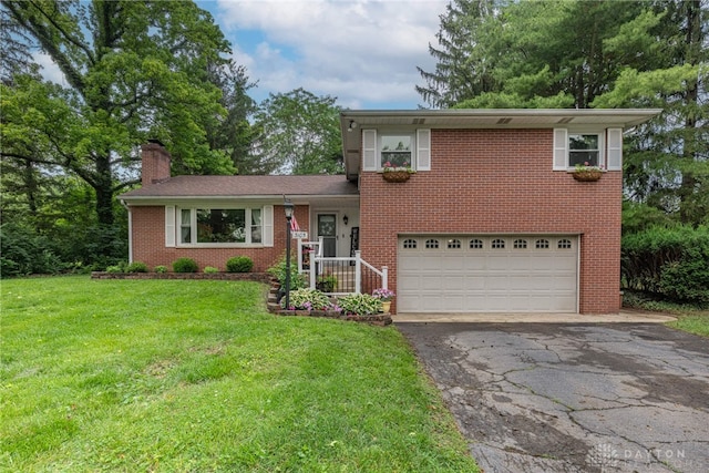 3105 Shadow Hill Rd, Middletown, OH 45042 - split level home featuring an attached garage, asphalt driveway, brick siding, a chimney, and a front yard
