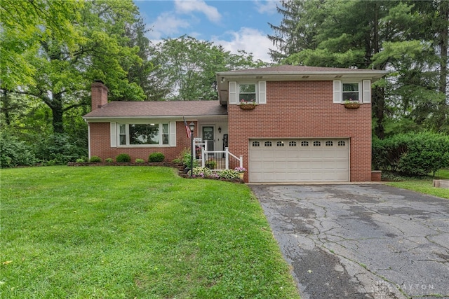 3105 Shadow Hill Rd, Middletown, OH 45042 - tri-level home with a garage, asphalt driveway, brick siding, a chimney, and a front lawn