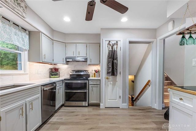 3105 Shadow Hill Rd, Middletown, OH 45042 - kitchen featuring stainless steel appliances, under cabinet range hood, gray cabinets, a ceiling fan, and light countertops