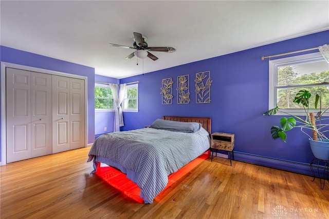 3105 Shadow Hill Rd, Middletown, OH 45042 - bedroom featuring a baseboard heating unit, wood finished floors, a closet, and a ceiling fan