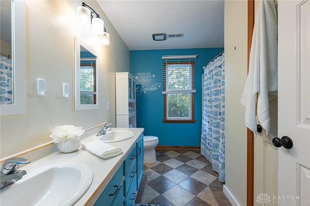 2610 Yorktown Ct, Beavercreek, OH 45434 - bathroom featuring double vanity and a textured ceiling