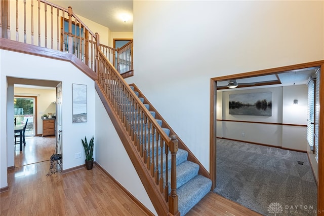 2610 Yorktown Ct, Beavercreek, OH 45434 - staircase featuring wood finished floors and a high ceiling