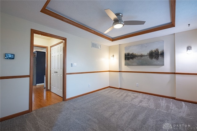 2610 Yorktown Ct, Beavercreek, OH 45434 - empty room featuring a raised ceiling, carpet floors, a textured ceiling, and a ceiling fan