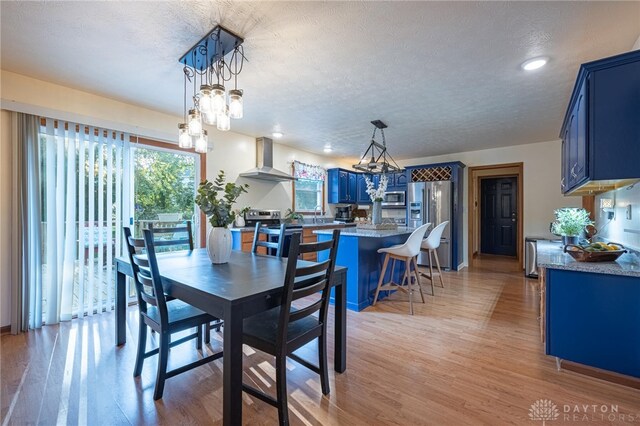 2610 Yorktown Ct, Beavercreek, OH 45434 - dining room with light wood-style floors, a textured ceiling, recessed lighting, and a chandelier
