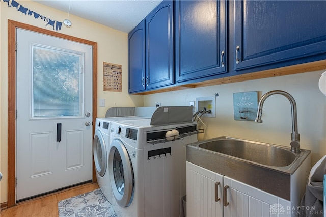 2610 Yorktown Ct, Beavercreek, OH 45434 - washroom with cabinet space, washing machine and clothes dryer, and light wood-style floors