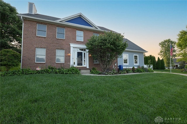 2610 Yorktown Ct, Beavercreek, OH 45434 - view of front facade with a front yard, a chimney, and brick siding