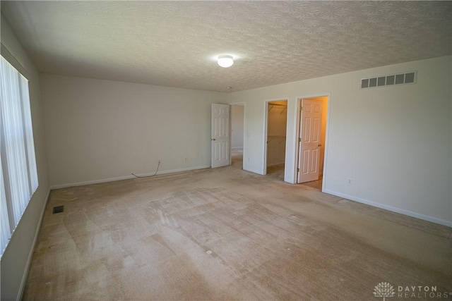 2710 Zoellners Way, Fairfield Twp, OH 45011 - unfurnished room featuring a textured ceiling, healthy amount of natural light, and light carpet