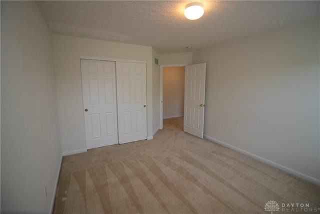 2710 Zoellners Way, Fairfield Twp, OH 45011 - unfurnished bedroom with a closet, light carpet, and a textured ceiling
