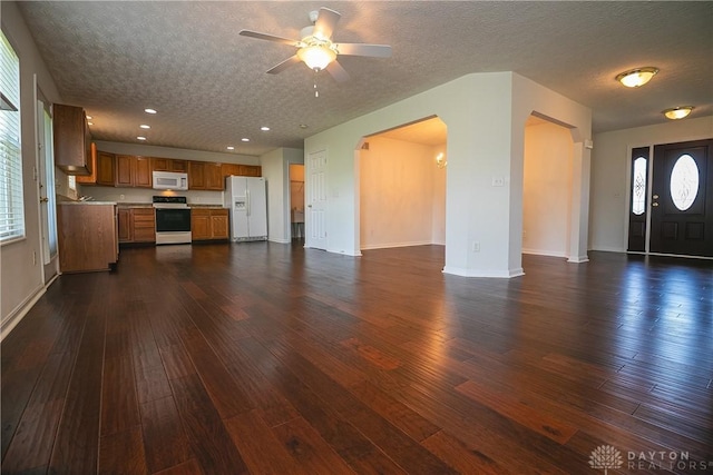 2710 Zoellners Way, Fairfield Twp, OH 45011 - unfurnished living room with dark wood-type flooring, arched walkways, a ceiling fan, a textured ceiling, and recessed lighting