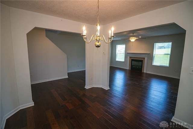 2710 Zoellners Way, Fairfield Twp, OH 45011 - unfurnished dining area featuring a chandelier, dark wood-style floors, a glass covered fireplace, a textured ceiling, and a ceiling fan